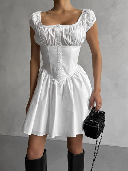 White dress worn by a person on a gray background