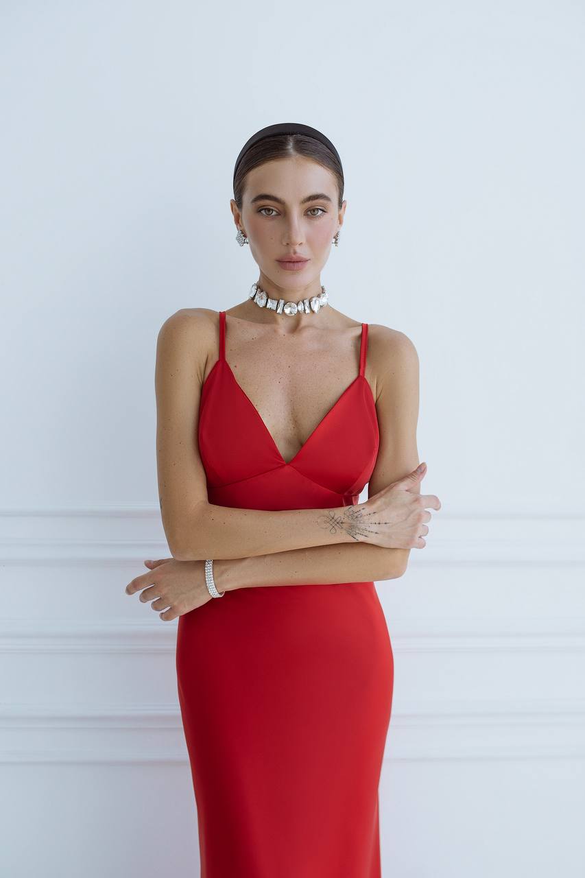 Woman wearing a red dress with a white background