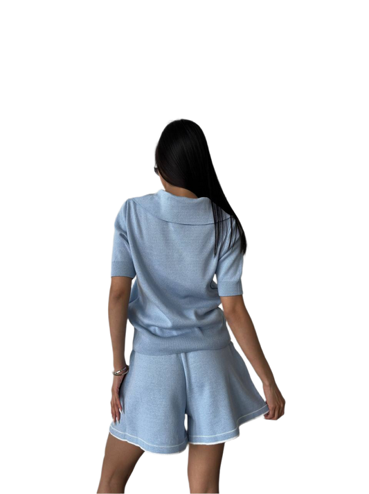 Woman wearing a light blue athletic outfit on a white background