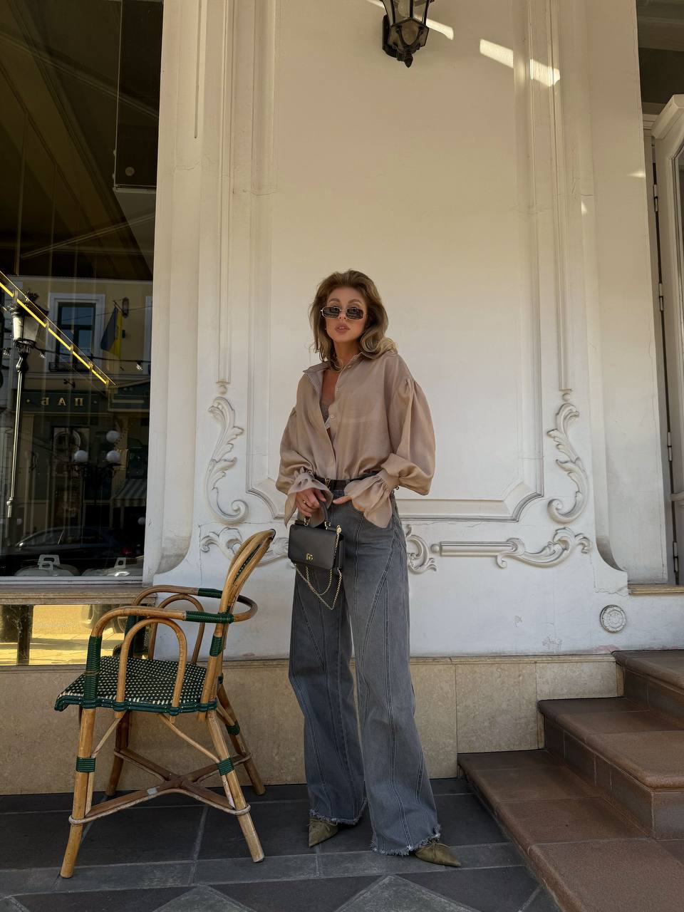 Woman standing in front of an ornate building entrance