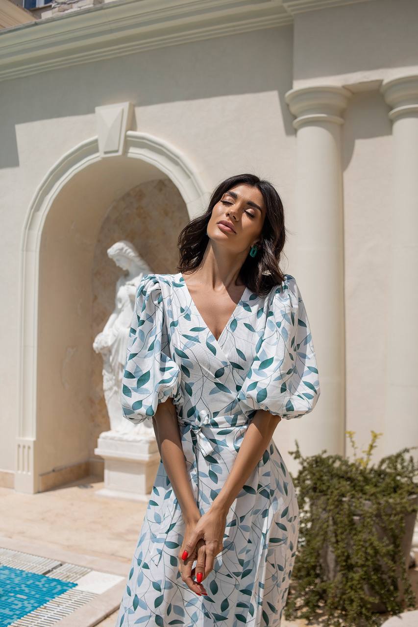 Woman in a floral dress standing in front of classical architecture