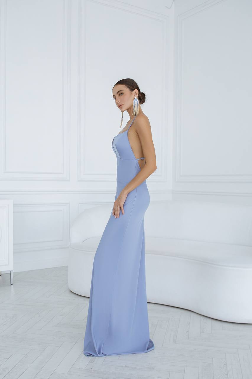 Woman wearing a light blue evening gown in a minimalistic setting