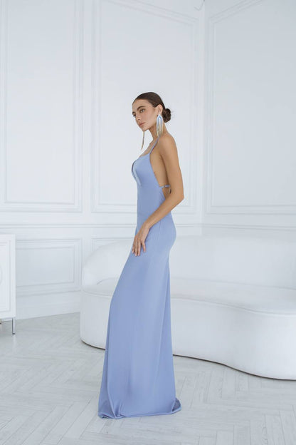 Woman wearing a light blue evening gown in a minimalistic setting