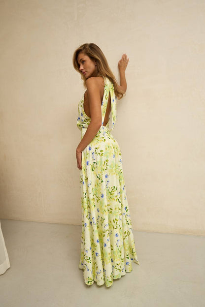 Woman wearing a floral dress against a beige background