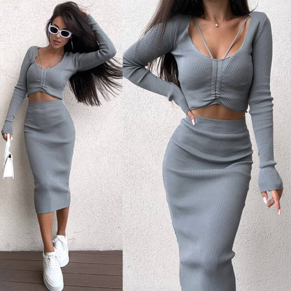 Woman wearing a gray long-sleeve top and skirt set against a white background