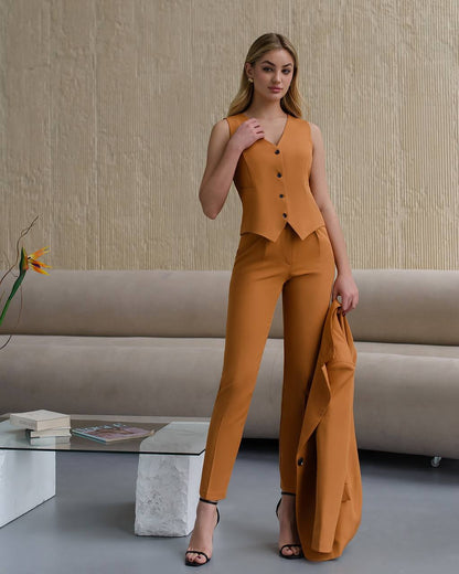 Woman in a mustard yellow outfit standing in a modern living room.