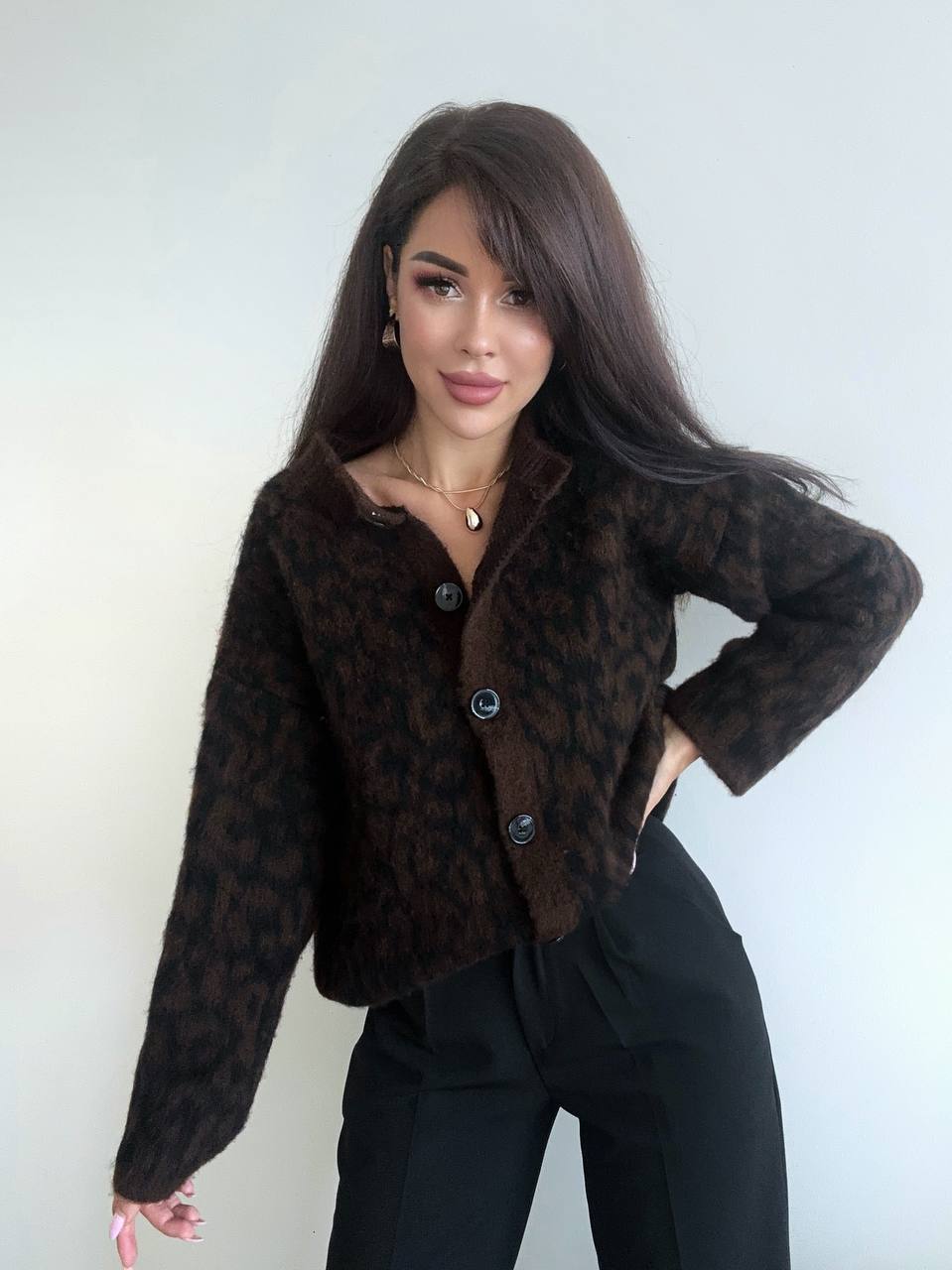 Woman wearing a leopard print jacket against a white background