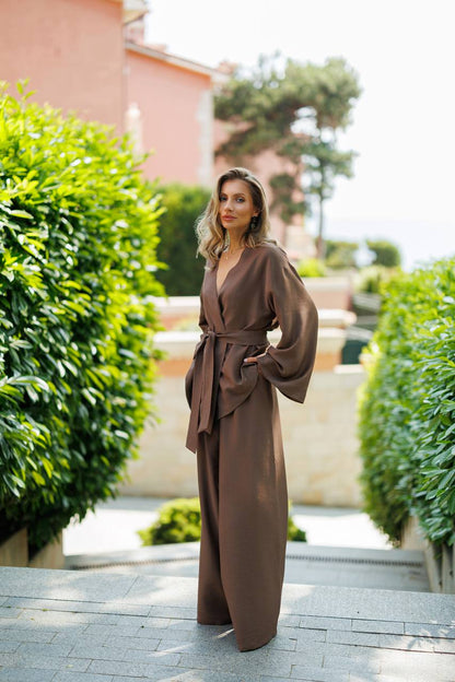 Woman in a brown dress standing in a garden setting
