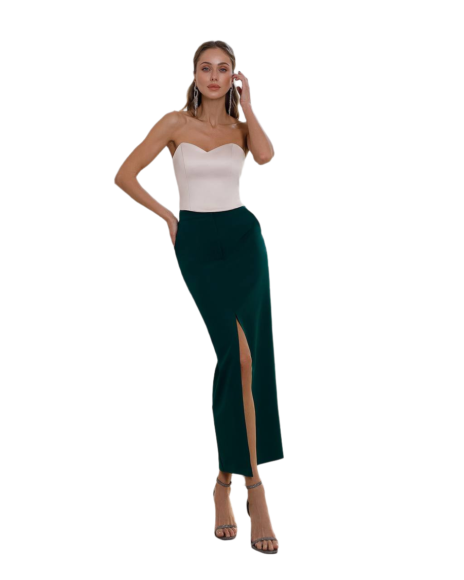 Woman wearing a strapless top and green skirt on a white background