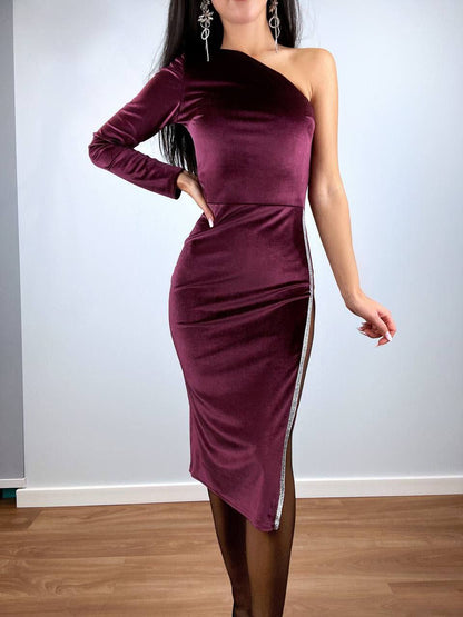 Purple one-shoulder dress worn by a person against a plain background