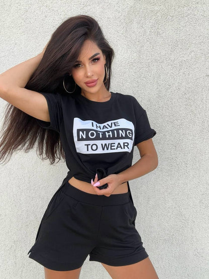 Woman wearing a black t-shirt with 'I have nothing to wear' text against a light gray background