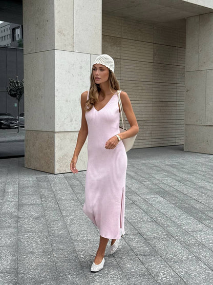 Woman in a pink dress standing in an urban setting