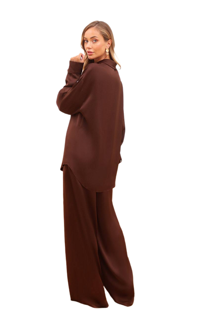 Woman wearing a brown outfit on a white background