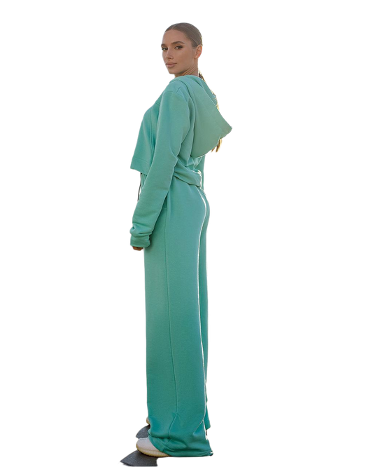 Person wearing a teal outfit on a white background