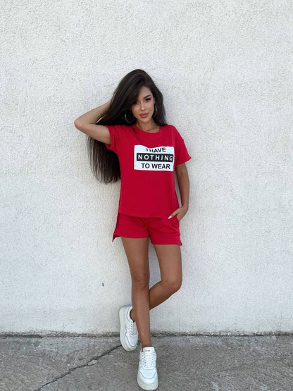 Woman wearing a red outfit with a graphic t-shirt against a white wall