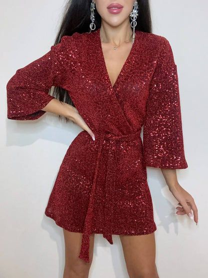 Red sequin dress worn by a model on a white background