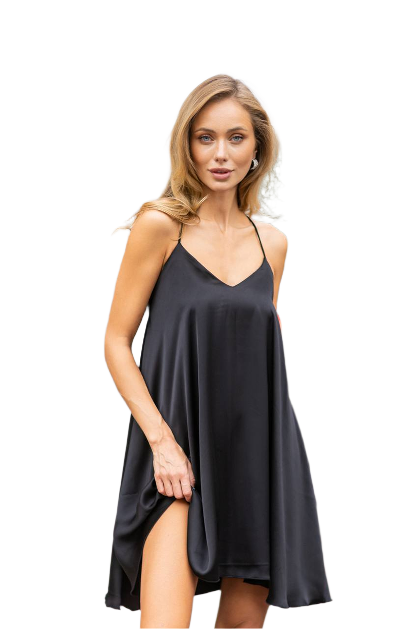 Woman wearing a black slip dress on a white background