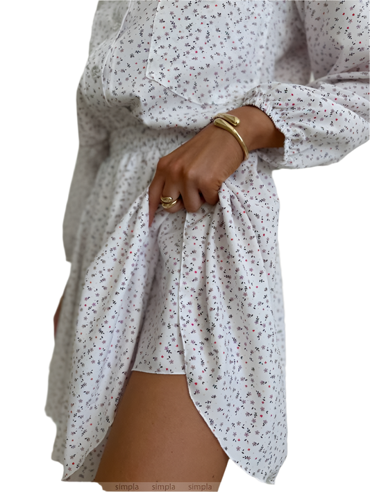 White floral dress with long sleeves on a white background