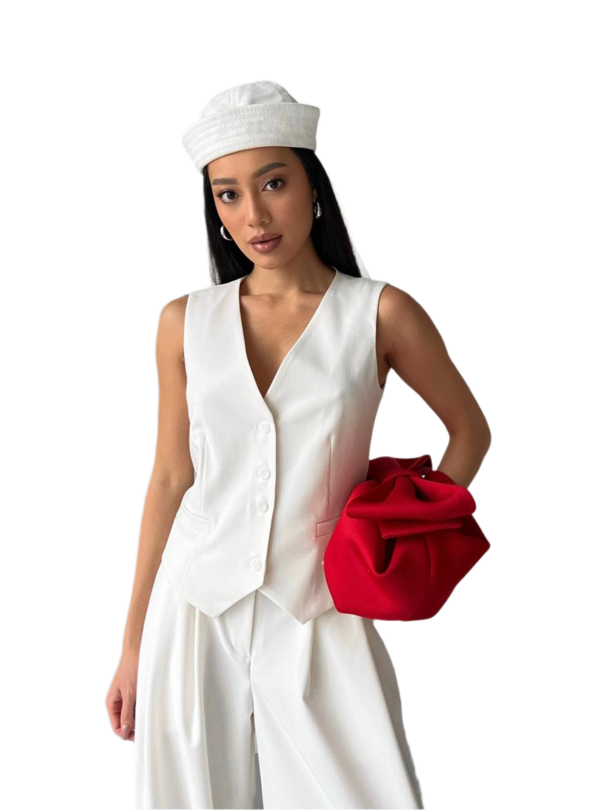Woman in a white outfit with a red clutch on a white background