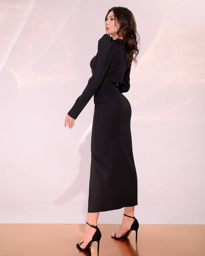 Woman wearing a black outfit against a white background