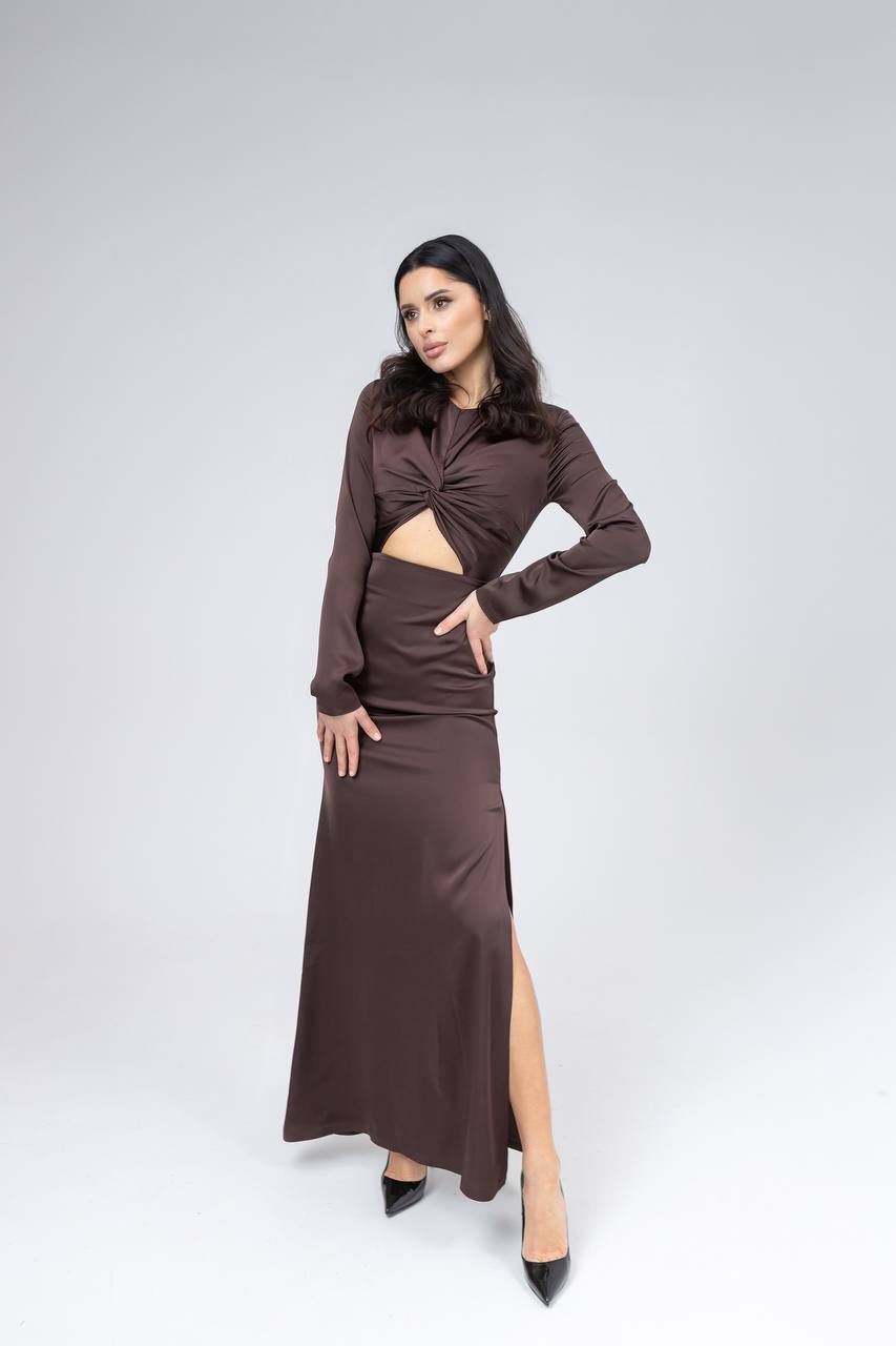 Woman wearing a brown long-sleeve top and skirt set on a white background