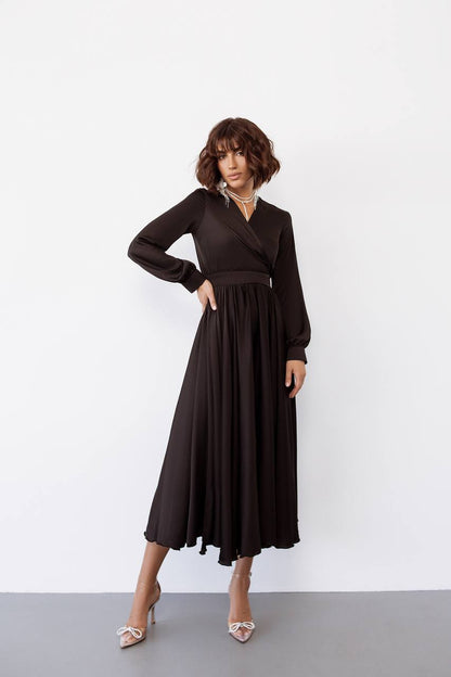 Woman wearing a black dress against a white background