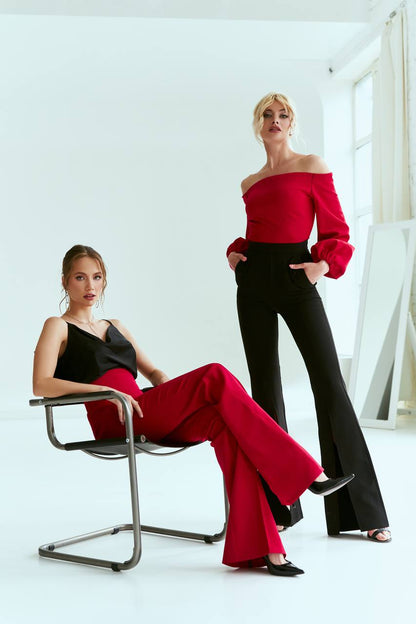 Two women in stylish outfits posing against a white background