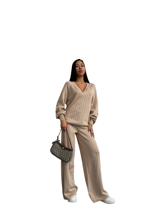 Woman wearing a beige striped outfit with a handbag on a white background