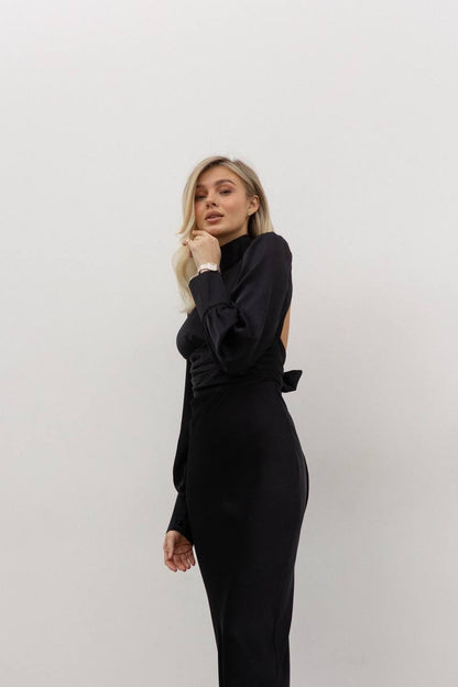 Woman wearing a black outfit against a white background