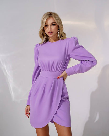 Woman wearing a purple dress against a white background