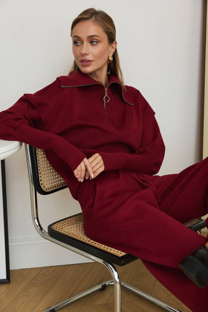 Woman wearing a burgundy outfit sitting on a chair.