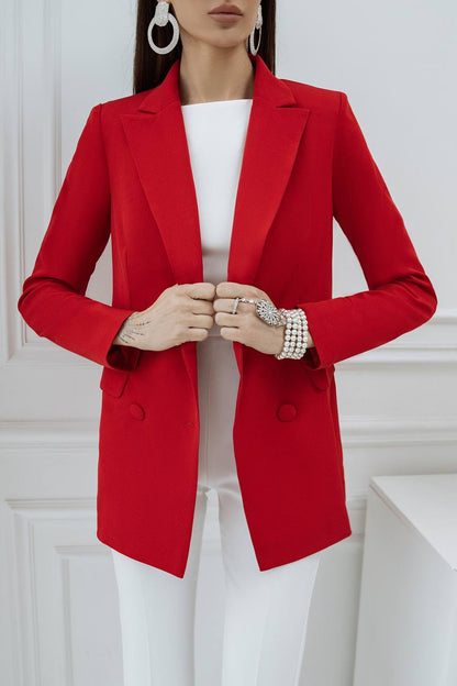 Person wearing a red blazer over a white outfit with a white background