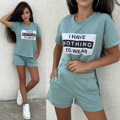 Woman wearing a teal outfit with a t-shirt and shorts, featuring text 'I HAVE NOTHING TO WEAR'.