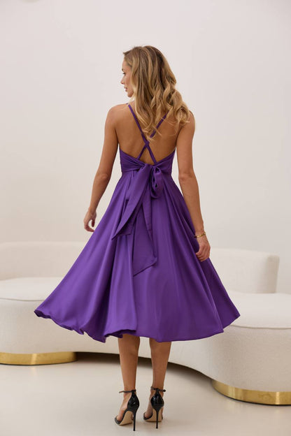 Woman wearing a purple dress with a white background