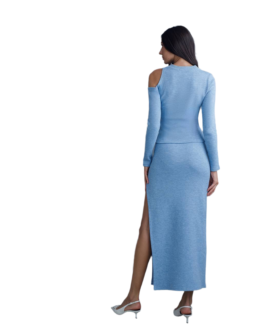 Woman wearing a light blue dress with long sleeves and a high slit on a white background