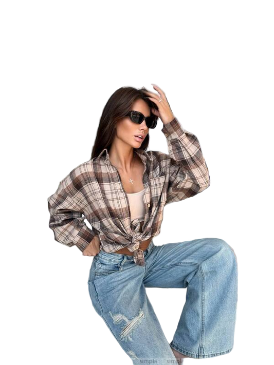 Woman wearing a plaid shirt and jeans on a white background