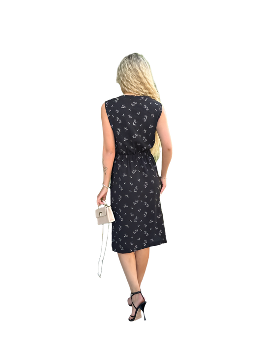 Woman wearing a black sleeveless dress with white floral pattern on a white background