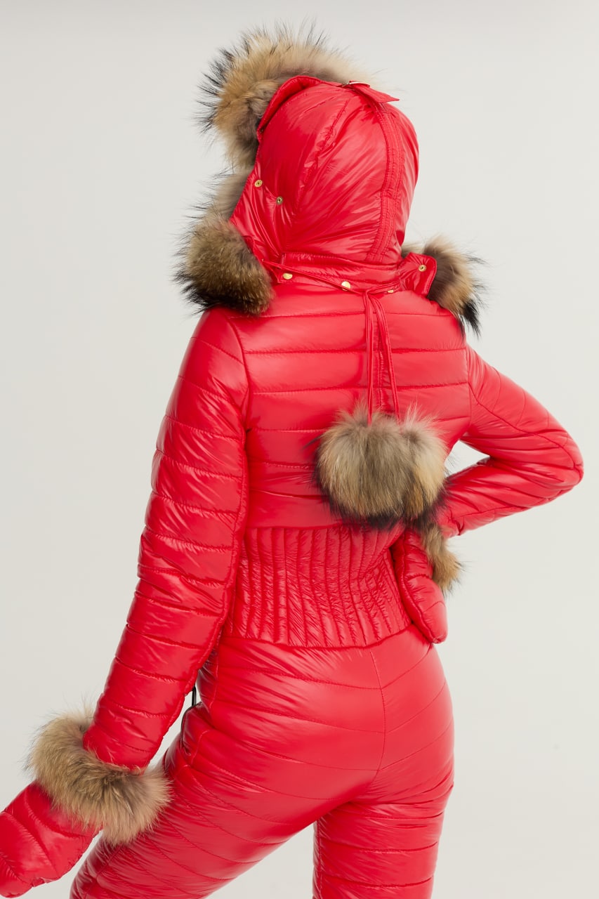 Red puffer jacket with fur hood and cuffs on a light gray background