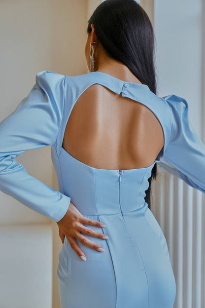 Light blue dress with open back worn by a person, standing against a neutral background.