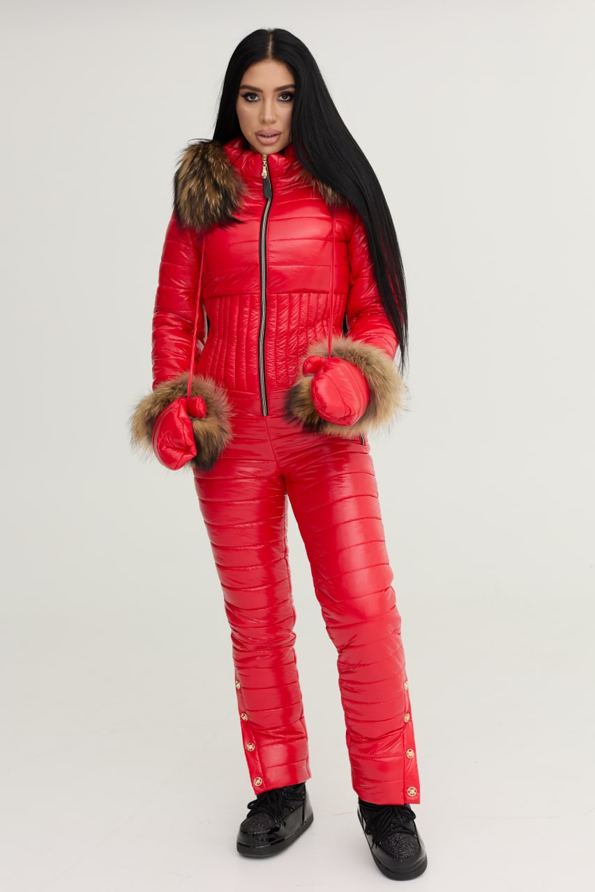 Person wearing a red puffer suit with fur trim on a white background