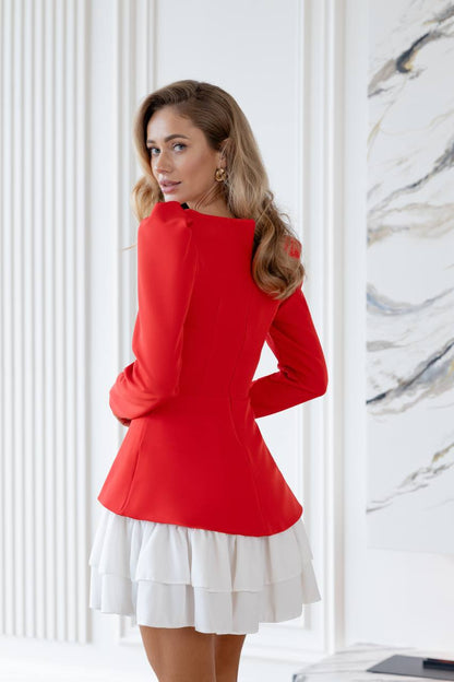 Woman wearing a red top and white skirt in a room with marble walls.