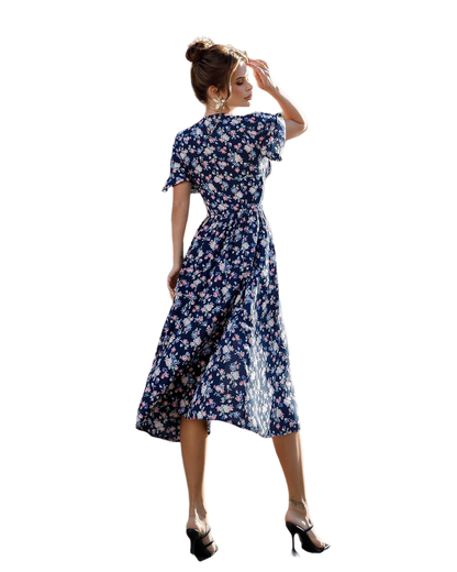 Woman wearing a blue floral dress on a white background