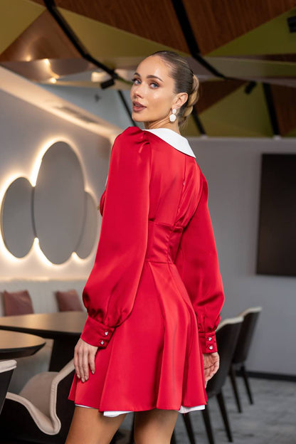 Woman in a red dress standing in a modern restaurant setting