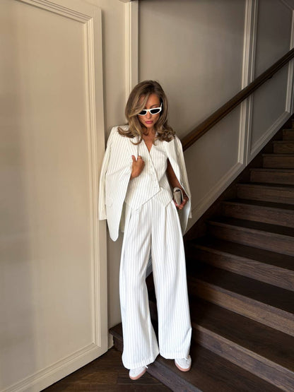 Woman in a white outfit standing on a staircase