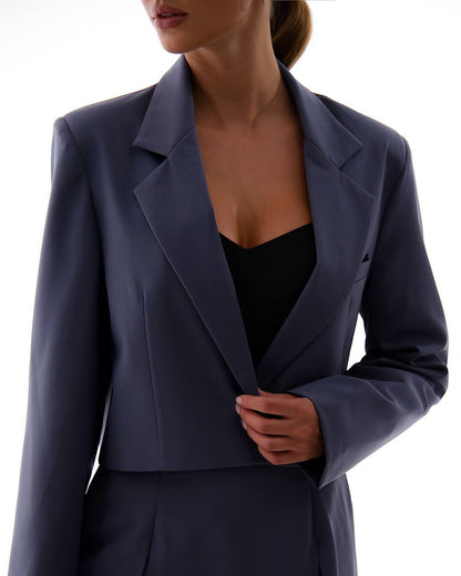 Navy blue blazer worn by a person on a white background