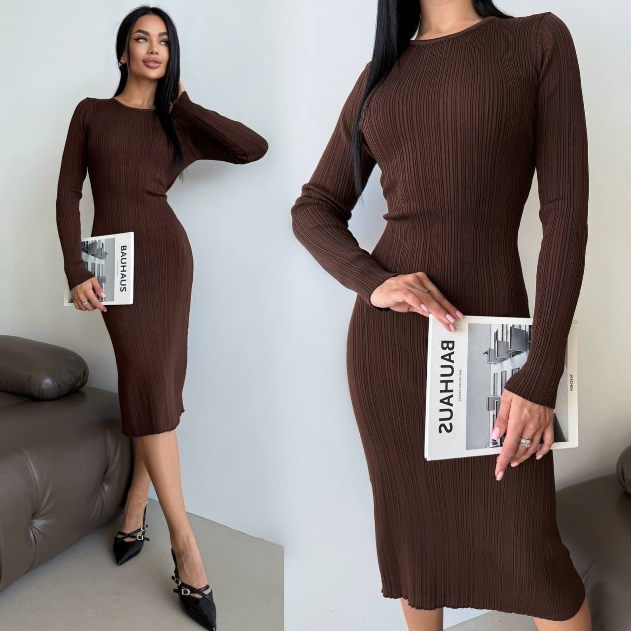 Woman wearing a brown ribbed dress holding a magazine against a white wall.
