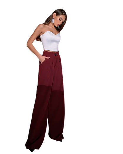 Woman wearing a white top and burgundy wide-leg pants on a white background
