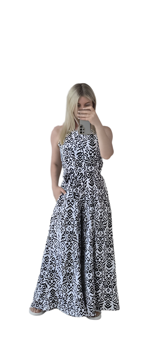 Woman wearing a black and white patterned dress on a white background