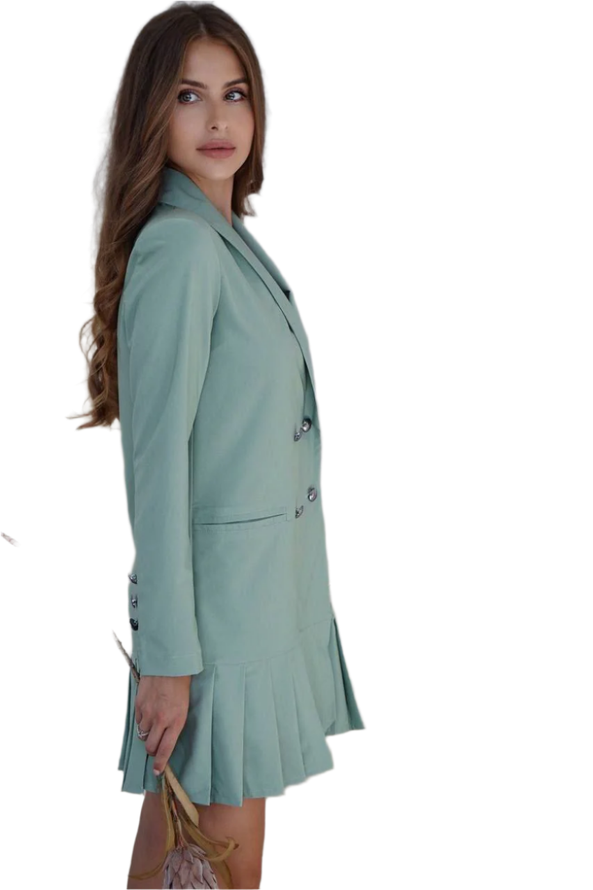 Woman wearing a light green blazer and skirt set on a white background