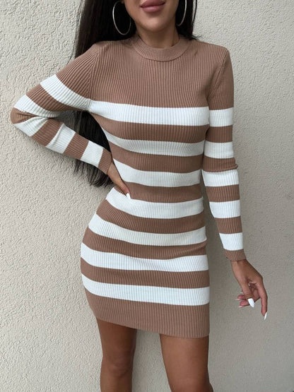 Brown and white striped dress worn by a person against a plain background